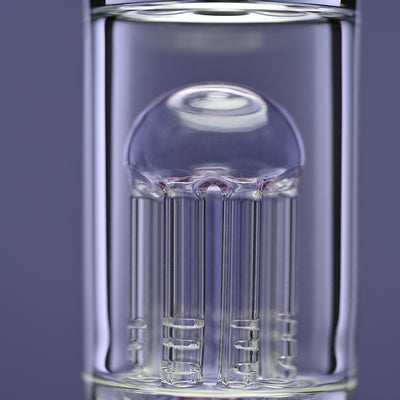A close-up view of a Castle Glassworks bong 8-arm percolator with purple accents, set against a solid purple background. The intricate percolator design is highlighted, showcasing the precision and craftsmanship involved in the piece. The purple tones in the glass complement the overall aesthetic, emphasizing the smooth and detailed glasswork.