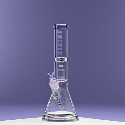 A glass beaker bong with purple accents stands against a solid purple background. The bong features the "CASTLE" logo on the neck and includes an 8-arm percolator for enhanced filtration. The image showcases the bong's sleek design and craftsmanship, with the purple tones creating a cohesive and visually appealing presentation.