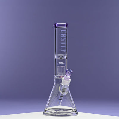 A glass beaker bong with purple accents is showcased against a solid purple background. The bong prominently displays the "CASTLE" logo vertically on the neck. It features an 8-arm percolator for enhanced filtration. The image highlights the bong's sleek design and craftsmanship, with the purple tones creating a cohesive and visually appealing presentation.