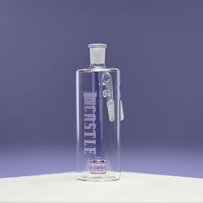 A glass ash catcher featuring the brand name Castle in purple letters on the side, with a purple matrix percolator. The ash catcher is set against a smooth purple background, which complements the color of the percolator and enhances the visual appeal of the piece. The clean lines and transparent glass design are highlighted, showcasing the modern and elegant craftsmanship of the ash catcher.