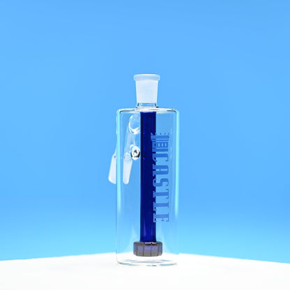 The image features a clear glass ash catcher with a dark blue showerhead percolator inside. The brand name "CASTLE" is etched vertically on the front of the ash catcher. The background is a solid, bright blue, which contrasts well with the dark blue percolator inside. The ash catcher is positioned on a white surface and photographed from a front-facing angle, showcasing its clean lines and the deep color of the percolator.
